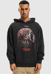 Black hoodie with a graphic design featuring a human profile with intricate details, red highlights, and text reading "FLYING HIGH."