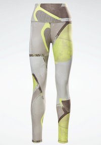 Höga leggings med ett abstrakt mönster i nyanser av brunt, grått och neongult mot en vit bakgrund.