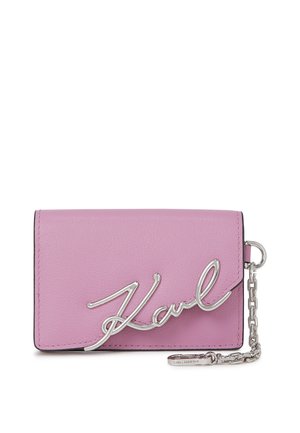 Pink leather wallet with silver chain and hardware. Features a scripted logo on the front. Rectangular shape with a smooth texture.