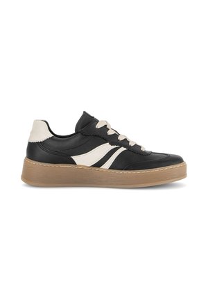 Black sneaker with white side stripes, beige laces, beige heel tab, and a thick light brown rubber sole, shown in profile on a white background.