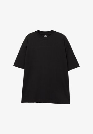Tricou oversized negru din bumbac. Are un gât rotund și mâneci scurte, cu o textură netedă, solidă și fără logo-uri vizibile.