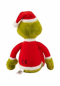 Green plush toy wearing a red and white Santa hat and red coat, with a soft texture and small white pom-pom on the hat. Tag visible.