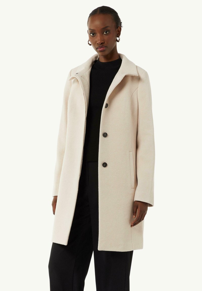 Helle beige Jacke aus Wollmischung, mit Kragen, Knopfverschluss und seitlichen Taschen. Taillierte Passform mit langen Ärmeln.