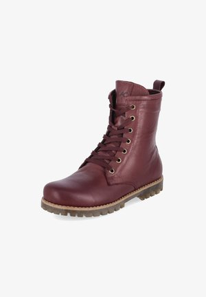 Dunkelroter Leder-Schnürstiefel mit brauner Gummisohle und Zuglasche hinten, leicht schräg auf weißem Hintergrund gezeigt.