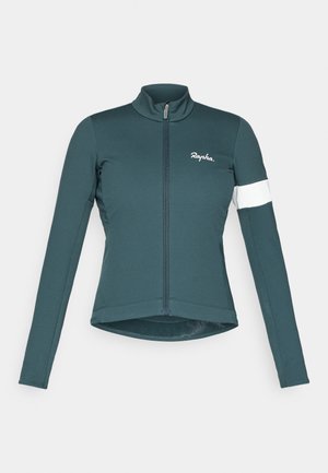Veste de cyclisme de couleur bleu canard fonc�é avec manches longues, col haut, fermeture éclair intégrale et bande blanche sur une manche. Fabriquée en tissu extensible et ajusté.