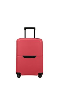 Hard-shell suitcase in coral with textured grooves. Features a black telescopic handle and four wheels for mobility. Brand logo displayed.