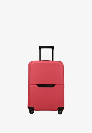 Hard-shell suitcase in coral with textured grooves. Features a black telescopic handle and four wheels for mobility. Brand logo displayed.
