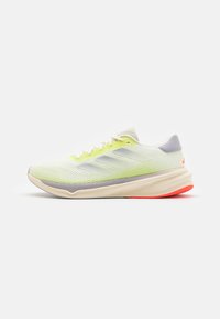 Light green and white running shoe with beige sole, gray accents, red heel grip, and mesh upper, shown in side profile on white background.