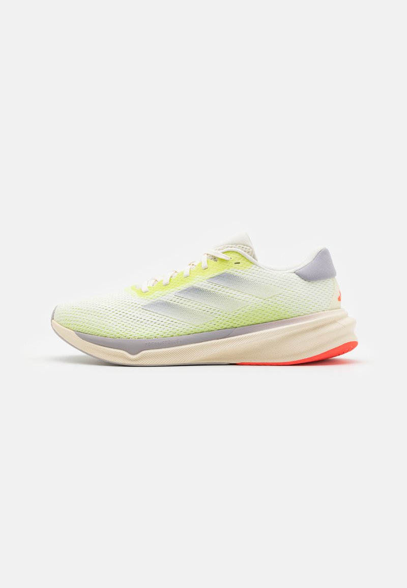Light green and white running shoe with beige sole, gray accents, red heel grip, and mesh upper, shown in side profile on white background.