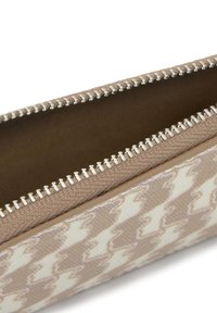 Beige patterned pouch with a houndstooth design. Features a silver zipper and a textured fabric exterior. Interior is a smooth tan color.