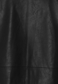 Black faux leather fabric with a textured surface, featuring subtle creases and a smooth, matte finish. Overall shape is flat and draped.