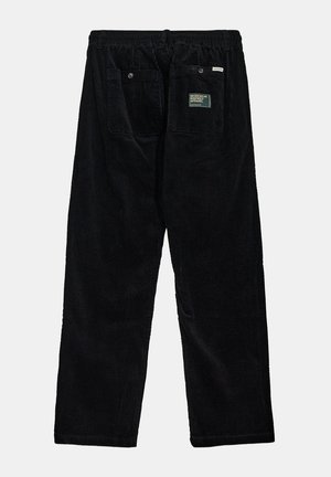 Pantaloni in velluto a coste neri con una vestibilità rilassata, caratterizzati da una vita elastica, due tasche posteriori e un'etichetta in tessuto sulla tasca destra.