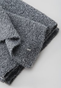 Gray, textured knit scarf made of soft fabric with silver metallic threads. Features a small branded tag sewn into the edge.