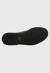 Black rubber shoe sole with a textured pattern of triangles and a central circular logo in red. Flat design suitable for casual wear.