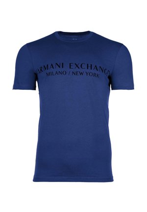 Camiseta de algodón azul marino con cuello redondo y mangas cortas. En el frente se muestra texto negro: "Armani Exchange Milano/New York."
