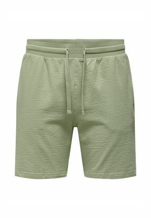 Lichtgroene shorts van gestructureerde stof met een elastische tailleband, verstelbaar trekkoord en zijzakken.
