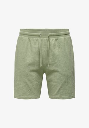 Lys grønne shorts lavet af tekstureret stof med elastisk talje, justerbar snøre og sidelommer.