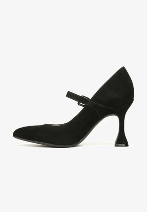Black suede Mary Jane shoe with a pointed toe, adjustable strap, and a unique flared heel design. Smooth texture and classic silhouette.