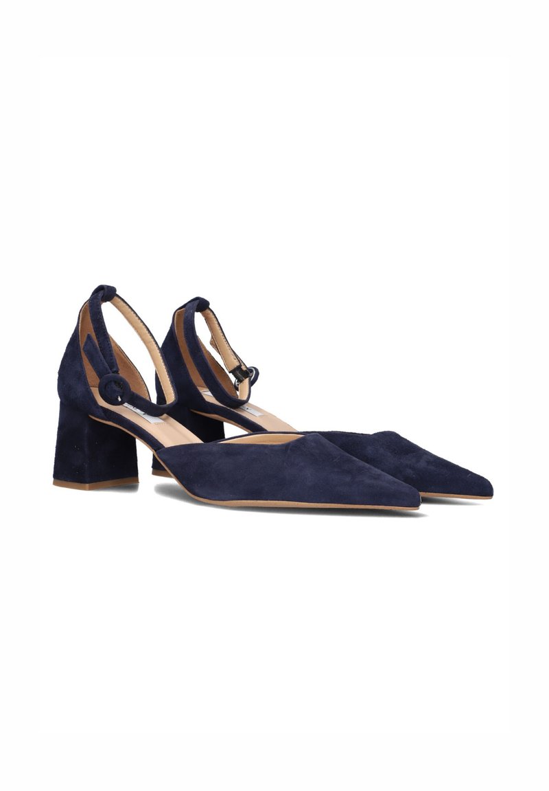 Navy blue suede block-heel shoes featuring a pointed toe, ankle strap with a loop detail, and a cushioned insole for comfort.