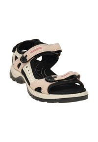 Pink and beige open-toe sandal with adjustable straps, black padding, and a sturdy black rubber sole featuring grooves for traction.