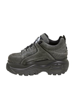 Gray high-top sneaker with thick, textured black sole, black laces, and white stitching detailing, viewed from the outer side.