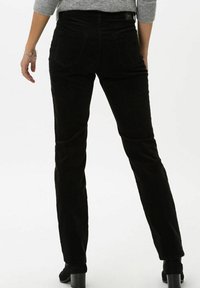 Black corduroy pants with a straight leg design. Features back pockets and a textured fabric. Smooth surface with minimal detailing.