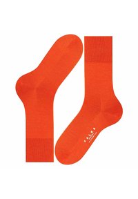 Helleorangene Socken mit glatter Textur, ausgestattet mit einem gerippten Bündchen und verstärktem Zehenbereich. Markenname auf der Sohle aufgedruckt.