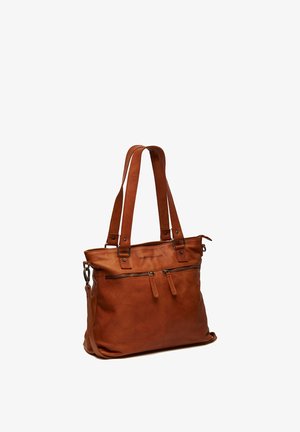 Borsa a mano in pelle marrone con due spallacci, tasca anteriore con zip e tracolla laterale staccabile su sfondo bianco.