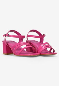 Sandalias de tacón rosa con múltiples tiras estrechas y una correa en el tobillo. Tacón cuadrado con un acabado suave y suela de goma.