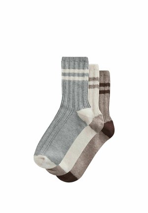 Three pairs of ribbed socks in gray, cream, and brown. Each pair features distinct stripe patterns and varying shades.