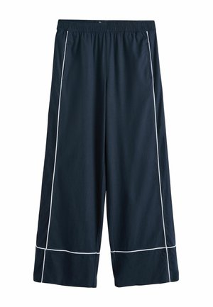 Pantalon large bleu marine avec surpiqûres blanches le long des coutures, taille élastique et poches latérales, présenté sur un fond blanc.