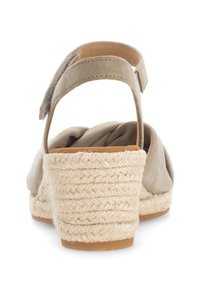 Sandali espadrillas beige con tacco a cuneo in juta testurizzata e una tomaia morbida e curve. Cinturino alla caviglia regolabile per una calzata sicura.