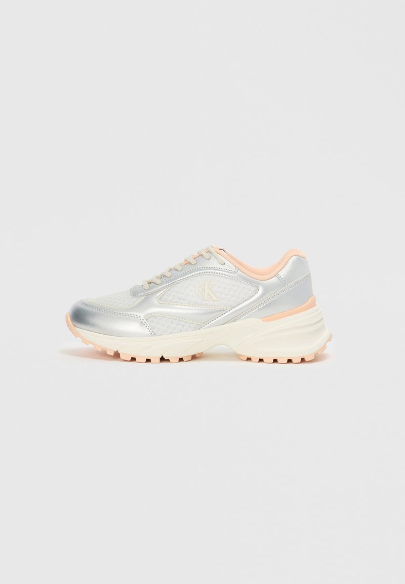 Silver mesh and synthetic sneakers with light pink accents, chunky white sole, and visible tread pattern on the outsole.