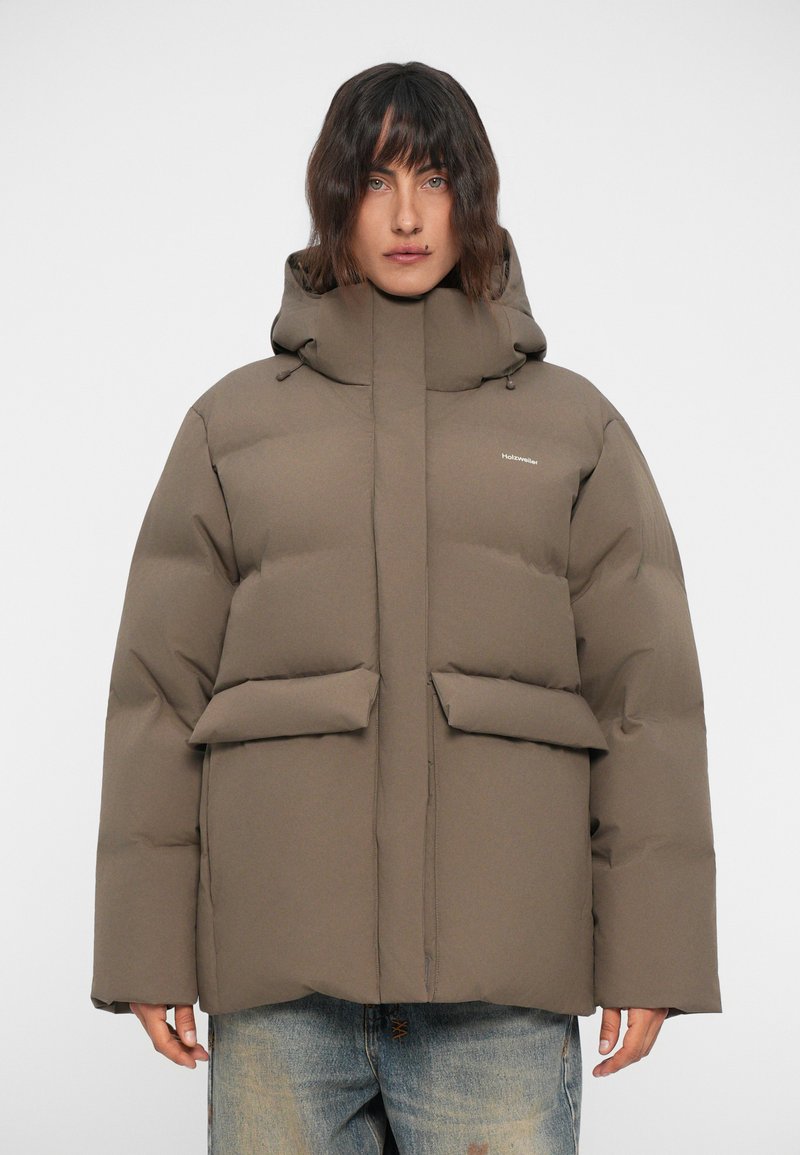 Brown puffer jacket with a high collar and hood, featuring two front pockets. Smooth texture and quilted design for insulation.
