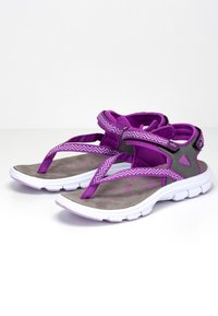 Purple athletic sandals feature textured gray footbeds and patterned straps. The design includes a cushioned sole with a white midsole.