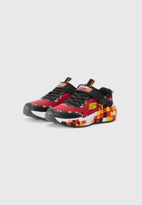 Multicolored athletic shoes featuring a red, black, and yellow pixelated design, a textured upper, and a cushioned sole with a contrasting white section.