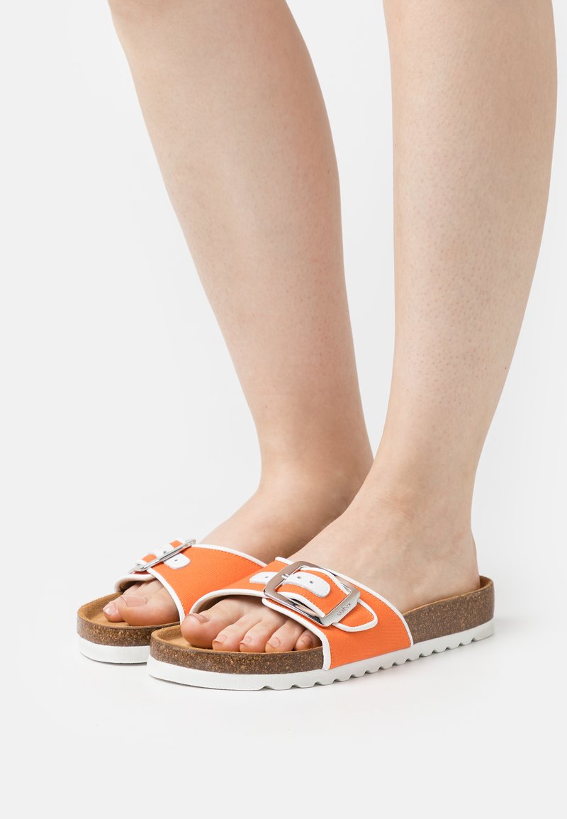 Des sandales à glissière orange avec une épaisse semelle en liège, des accents blancs et un détail de boucle en argent. Le design présente un style ouvert à l'avant et une semelle intérieure.