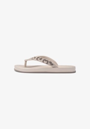 Beige flip-flop sandal with cushioned sole and decorative beaded leopard pattern on the strap.