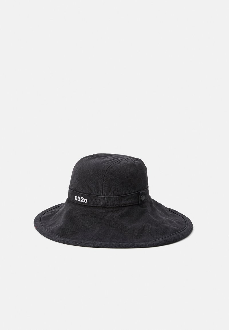 Black cotton bucket hat with a wide brim, featuring a side strap and button detail. The band has the text "032c" embroidered on it.