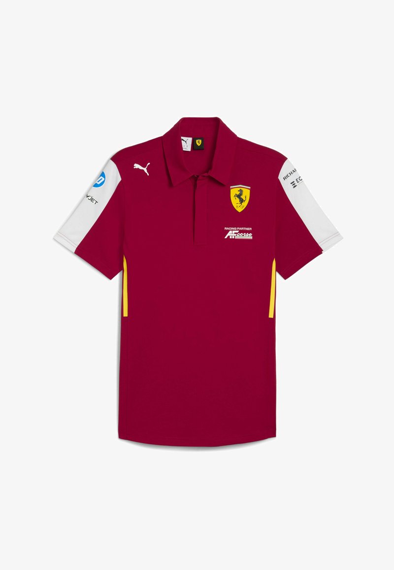 Bordo polo krekls ar apkakles kaklu, dzelteniem akcentiem un baltajām piedurknēm. Satur izšūtus logo un sponsoru tekstu dažādās pozīcijās.