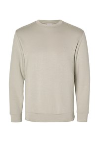 Sudadera de un suave color beige claro, confeccionada en tejido blando, con un cuello redondo, mangas largas y puños y dobladillo acanalados. Textura lisa, diseño minimalista.