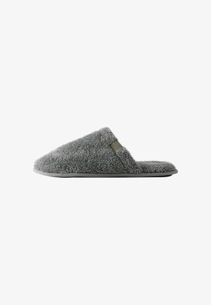 Gray fleece slipper with a textured upper, open toe design, and a flexible rubber sole. Features a small, rectangular accent detail.
