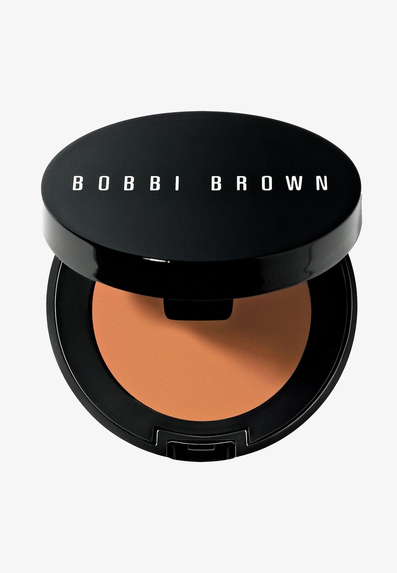 Schwarzer Compact mit dem weißen "BOBBI BROWN"-Logo. Der Deckel ist glänzend und das Innere enthält ein glattes, mittleres bronzefarbenes Puder.