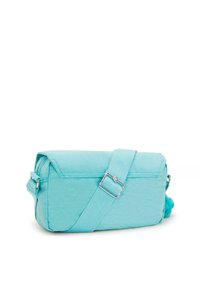 A turquoise messenger bag with a rectangular shape, zip closure, an adjustable strap, and a fluffy pom-pom accent on the side.
