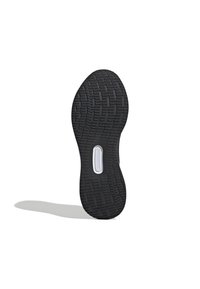Suela de zapato de goma negra con un patrón texturizado para mayor agarre, con un acento blanco cerca del centro. La forma es ergonómica y curvada.