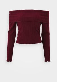 Burgundiszínű, vállnélküli felső bordás anyagból, hosszú ujjú, testhezálló fazonnal és lekerekített szegéllyel az alján.
