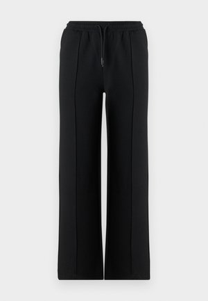 Juodos spalvos plačios sportinės kelnės su elastinga juosmens juosta ir raišteliu. Pagamintos iš minkštos medžiagos, su priekine siūle dekoratyvumui.