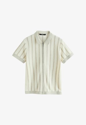 Kurzärmeliges, cremefarbenes Strick-Polohemd mit vertikalen, strukturierten Streifen und einem zentralen Reißverschluss vor weißem Hintergrund.