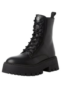 Bottine en cuir noir avec une plateforme épaisse, bout arrondi, fermeture à lacets à l'avant et tirette en forme de boucle. Présente une semelle texturée avec des crampons profonds.