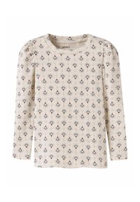 Długi rękaw top w kremowym materiale z kwiatowym wzorem w niebieskie i brązowe kolory. Charakteryzuje się marszczonymi ramionami i prążkowaną teksturą. Okrągły dekolt.